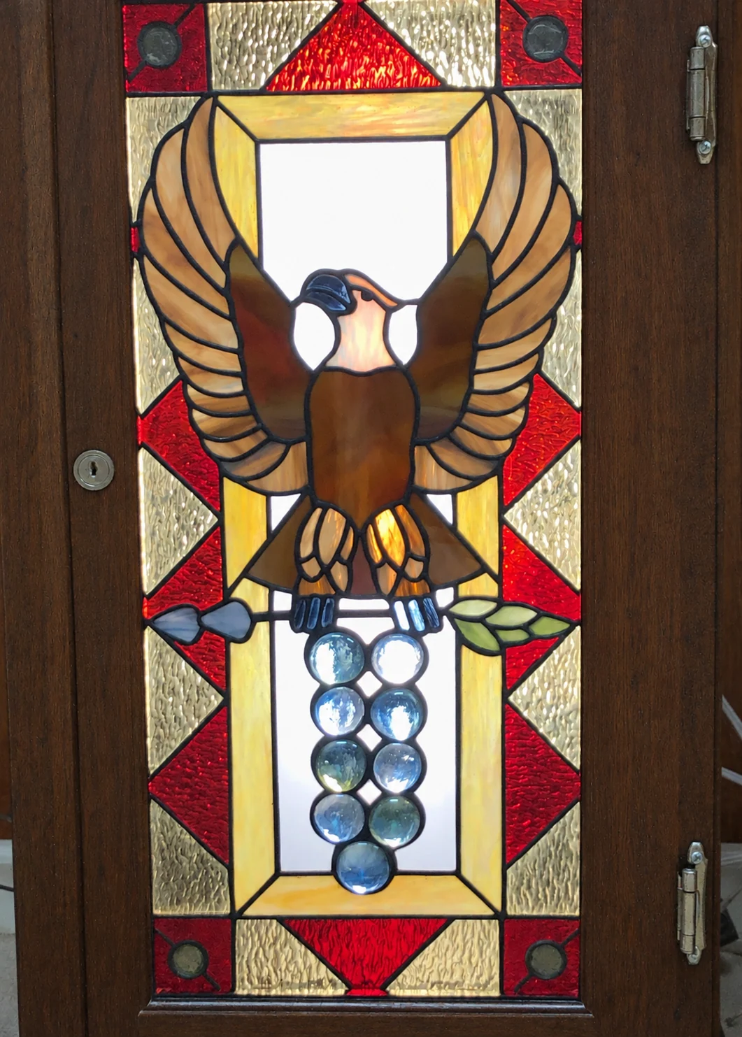 Eagle & fruit panel installed in a wooden door