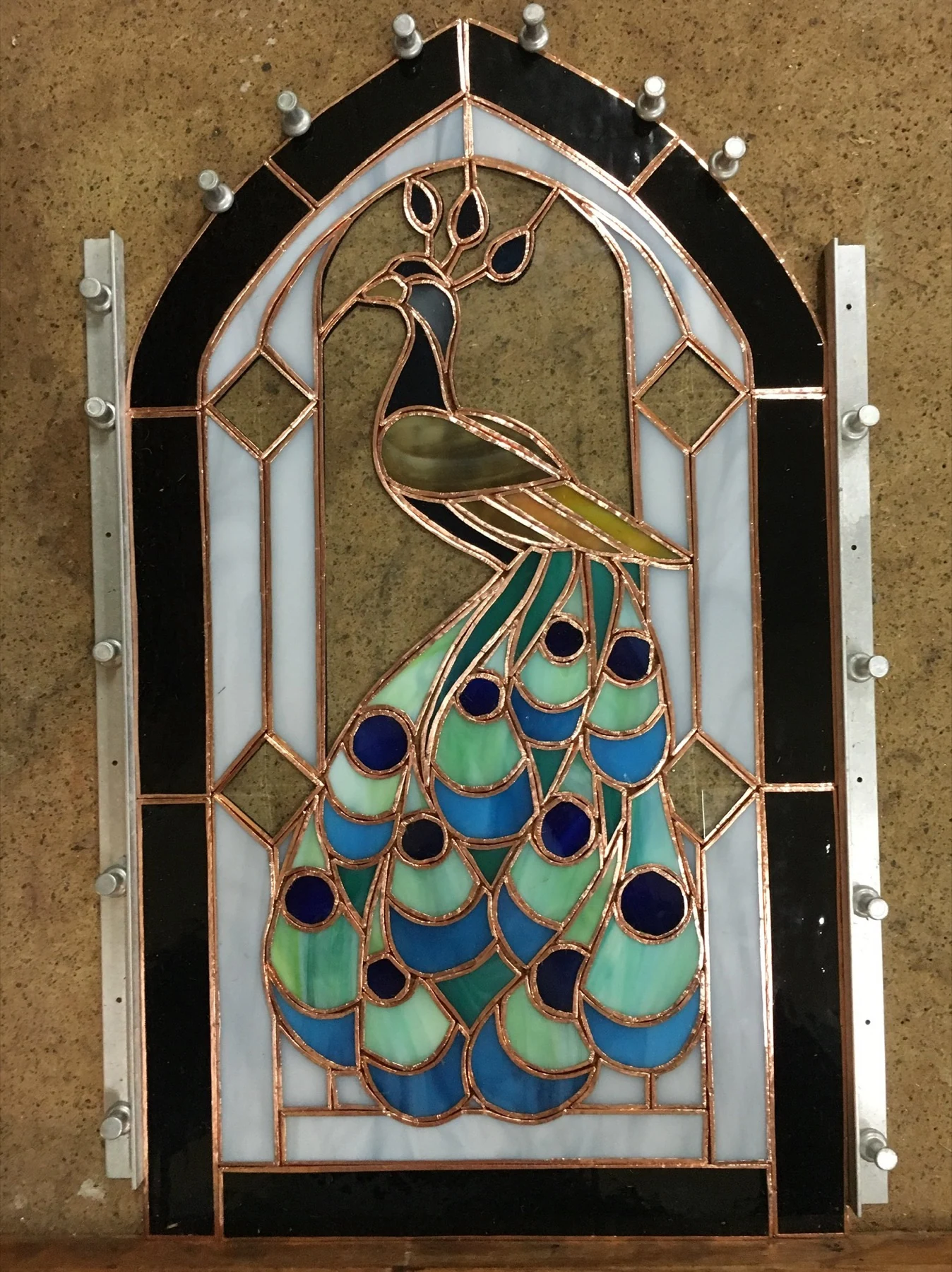 Peacock arched panel during assembly on the workbench